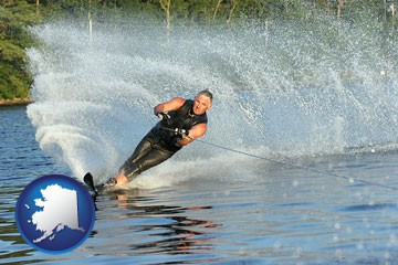 a young man waterskiing on a lake - with Alaska icon