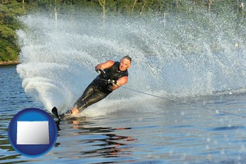 a young man waterskiing on a lake - with Colorado icon