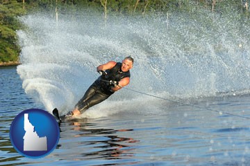 a young man waterskiing on a lake - with Idaho icon