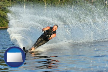 a young man waterskiing on a lake - with North Dakota icon