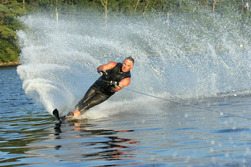 a young man waterskiing on a lake